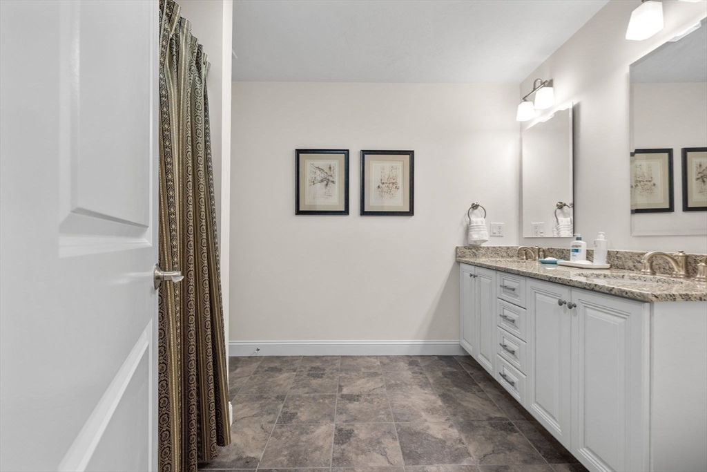11 Cranberry Lane, Unit 11 Middleton, MA 01949 - Photo 13 of 29 a bathroom with a sink a mirror and a shower