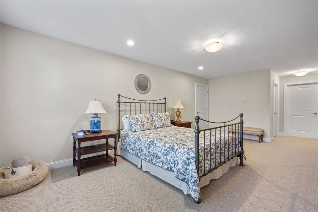 11 Cranberry Lane, Unit 11 Middleton, MA 01949 - Photo 17 of 29 a bedroom with a bed and a lamp with the bathroom