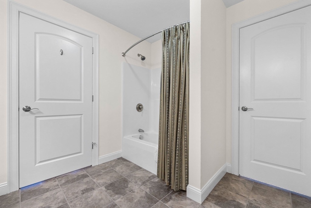 11 Cranberry Lane, Unit 11 Middleton, MA 01949 - Photo 20 of 29 a view of a bathroom with a shower and a sink