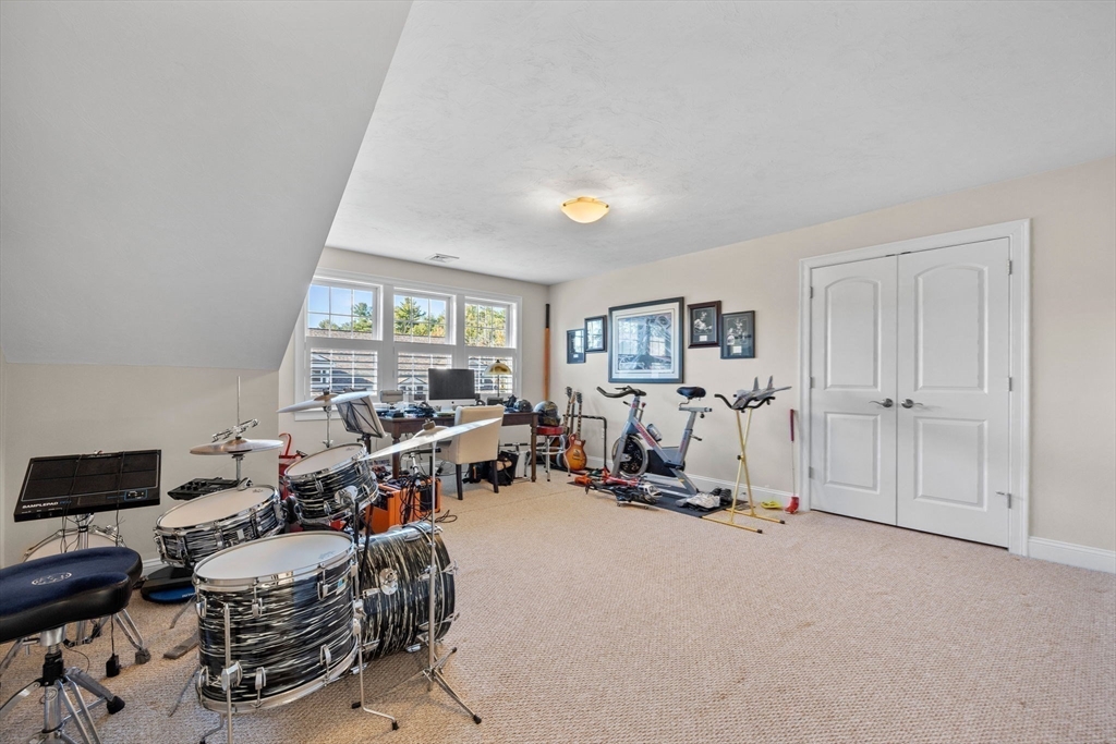 11 Cranberry Lane, Unit 11 Middleton, MA 01949 - Photo 21 of 29 a room with gym equipment and a window