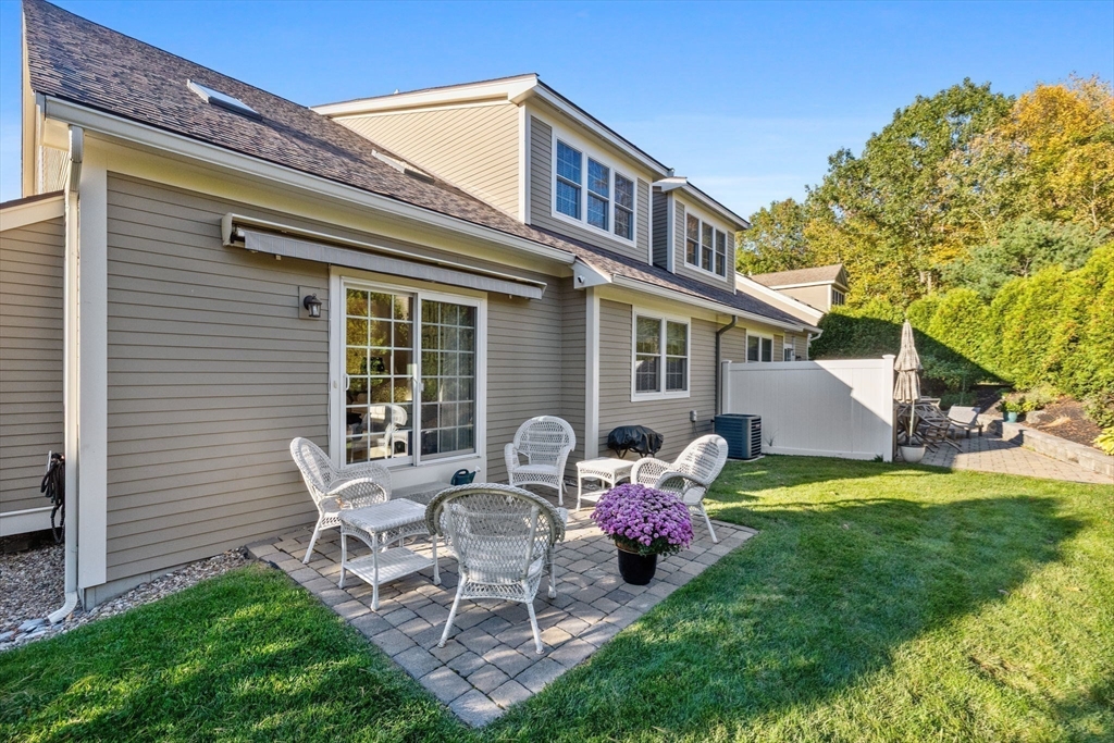 11 Cranberry Lane, Unit 11 Middleton, MA 01949 - Photo 24 of 29 a view of a chair and table in backyard of the house