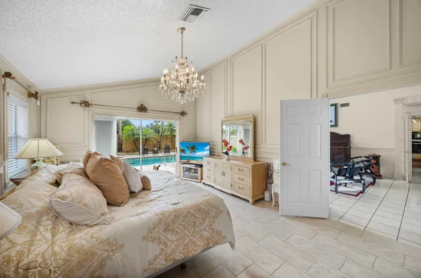 a dining room with furniture a chandelier and window