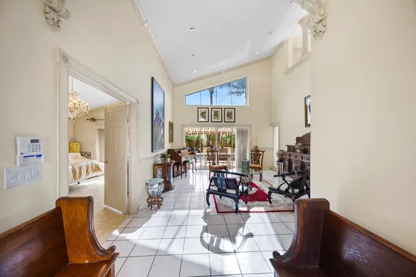 a living room with furniture a table and a chandelier
