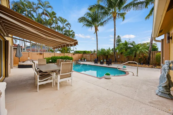 a view of a chairs with a fire pit and wooden fence