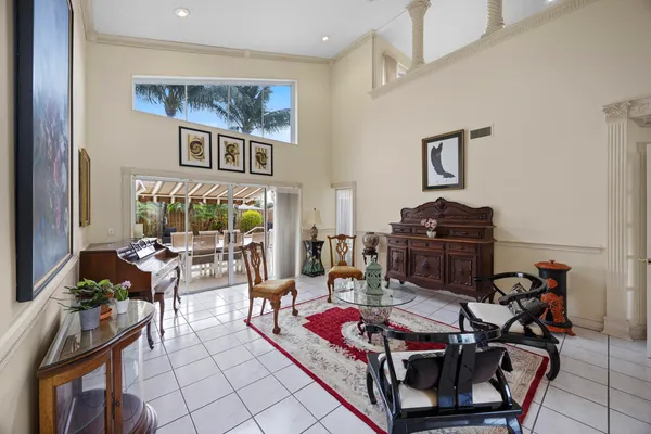 a view of a dining room with furniture a rug and wooden floor