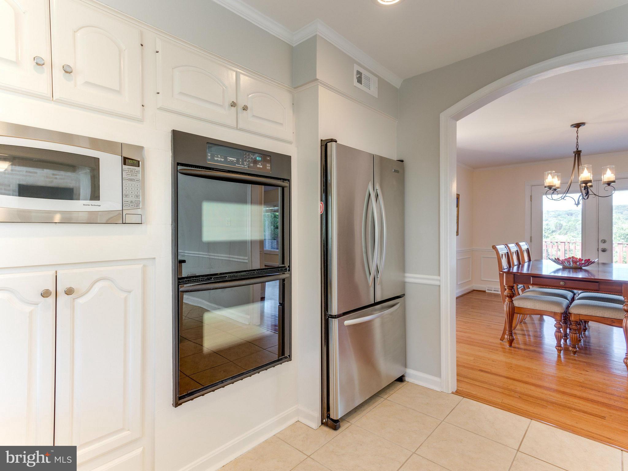 20473 Gleedsville Road Leesburg, VA 20175 - Photo 11 of 30 a kitchen with granite countertop a refrigerator and a stove top oven
