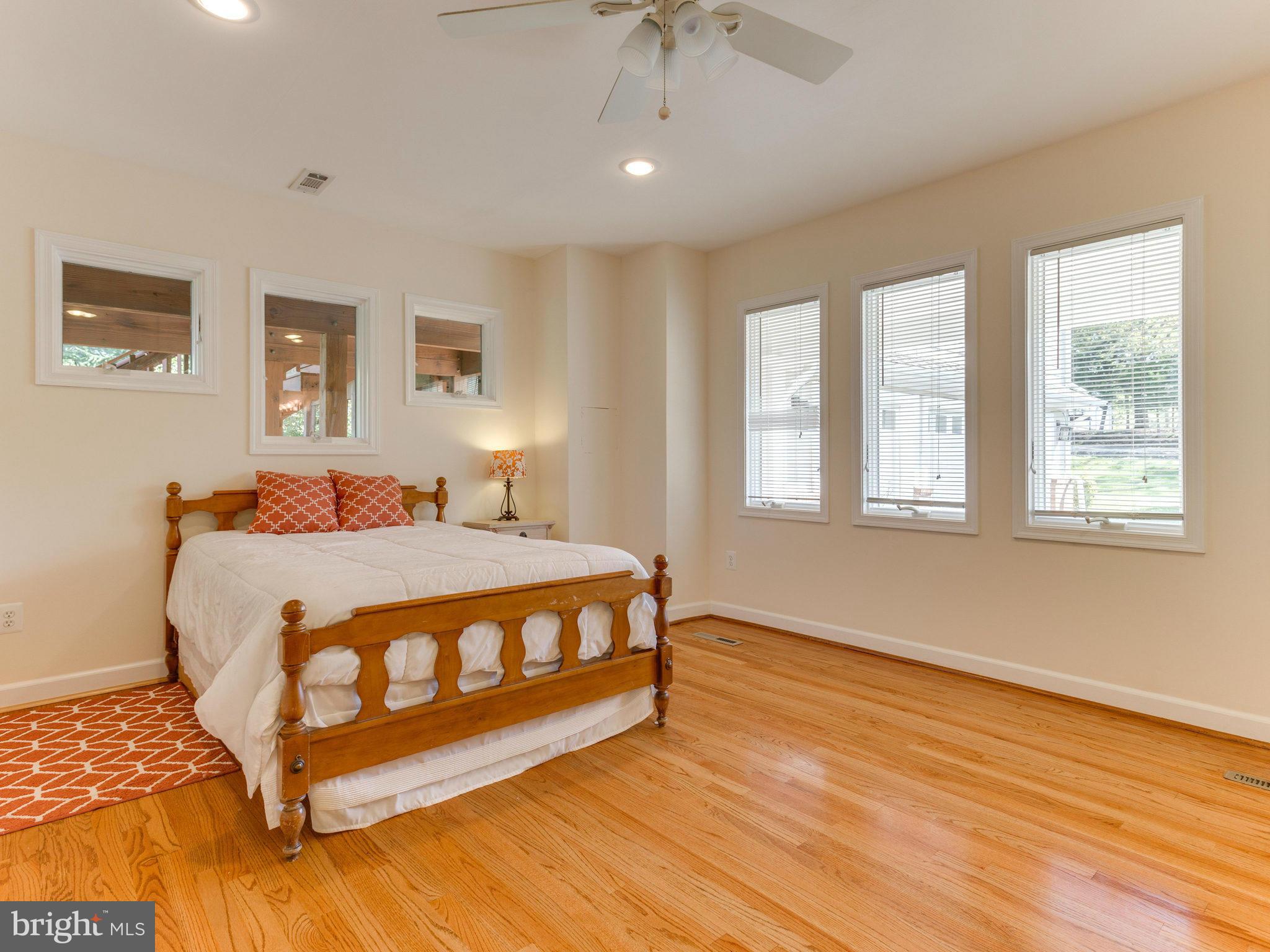 20473 Gleedsville Road Leesburg, VA 20175 - Photo 17 of 30 a spacious bedroom with a bed and wooden floor