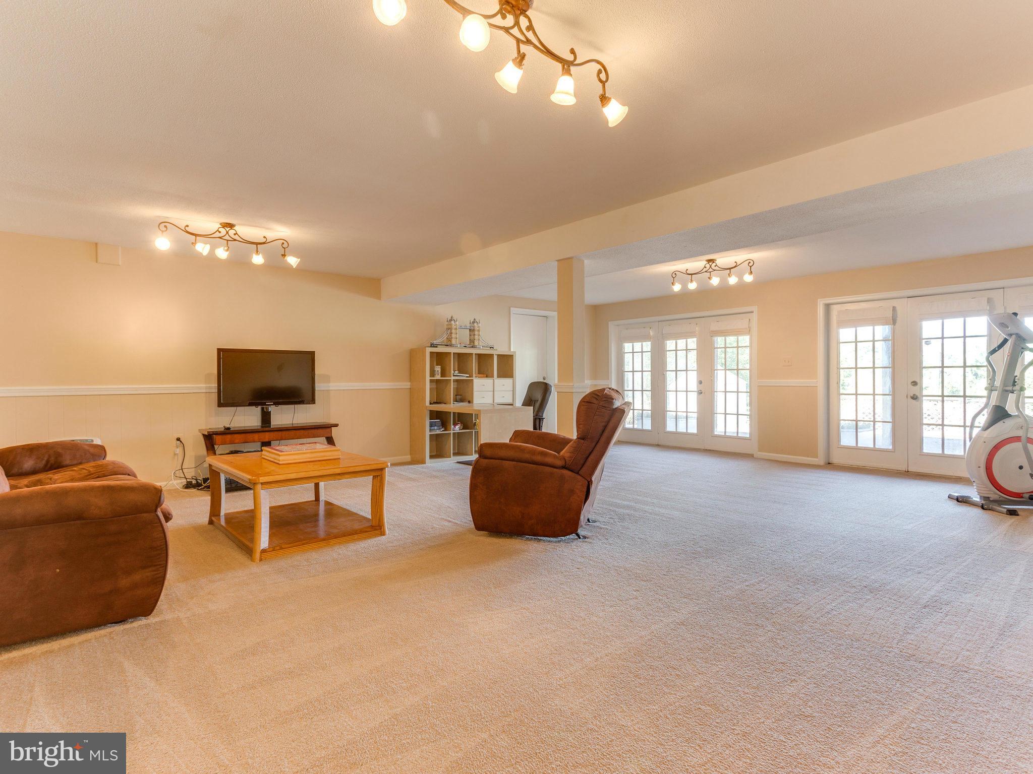 20473 Gleedsville Road Leesburg, VA 20175 - Photo 25 of 30 a living room with furniture and a flat screen tv