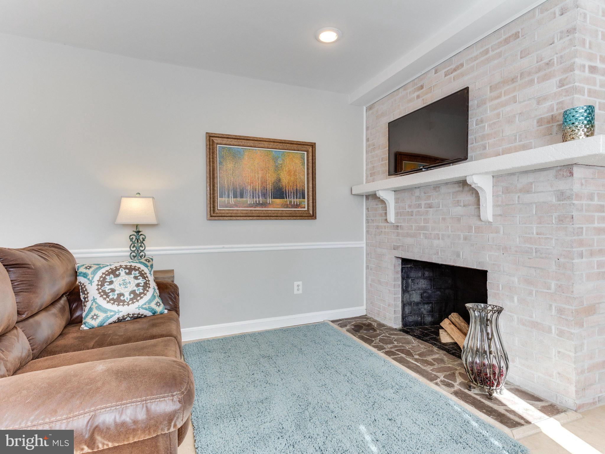 20473 Gleedsville Road Leesburg, VA 20175 - Photo 8 of 30 a living room with furniture and a fireplace
