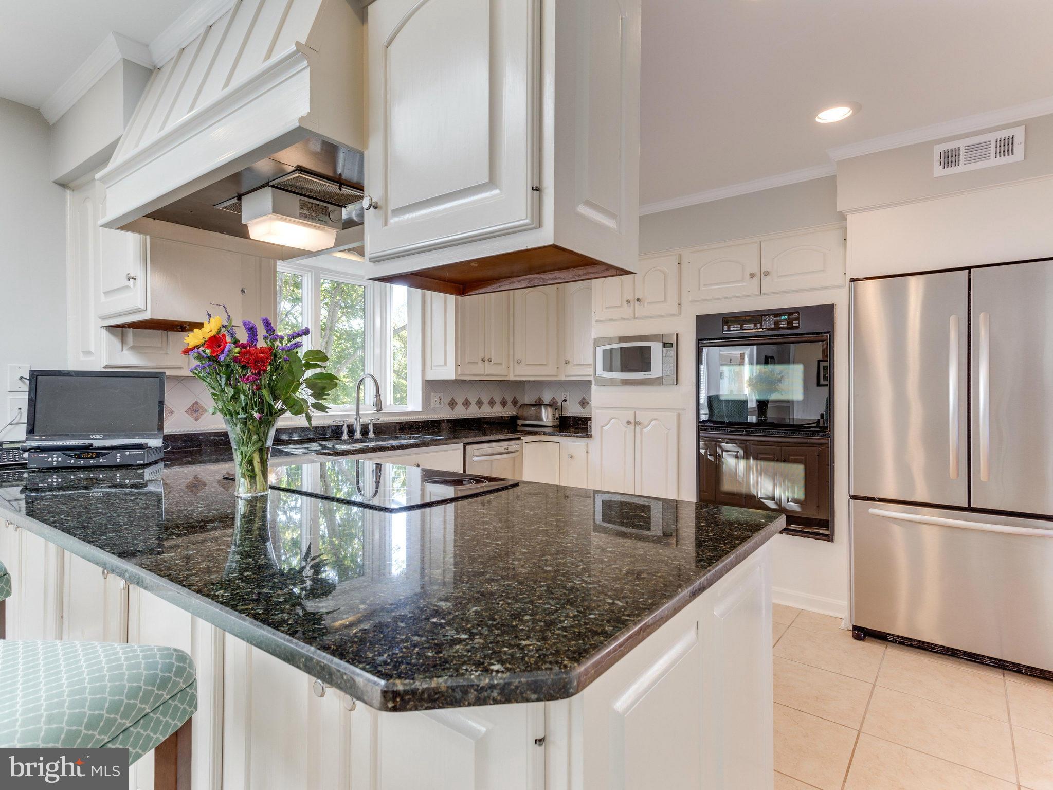 20473 Gleedsville Road Leesburg, VA 20175 - Photo 9 of 30 a kitchen with stainless steel appliances granite countertop a refrigerator a stove and a sink