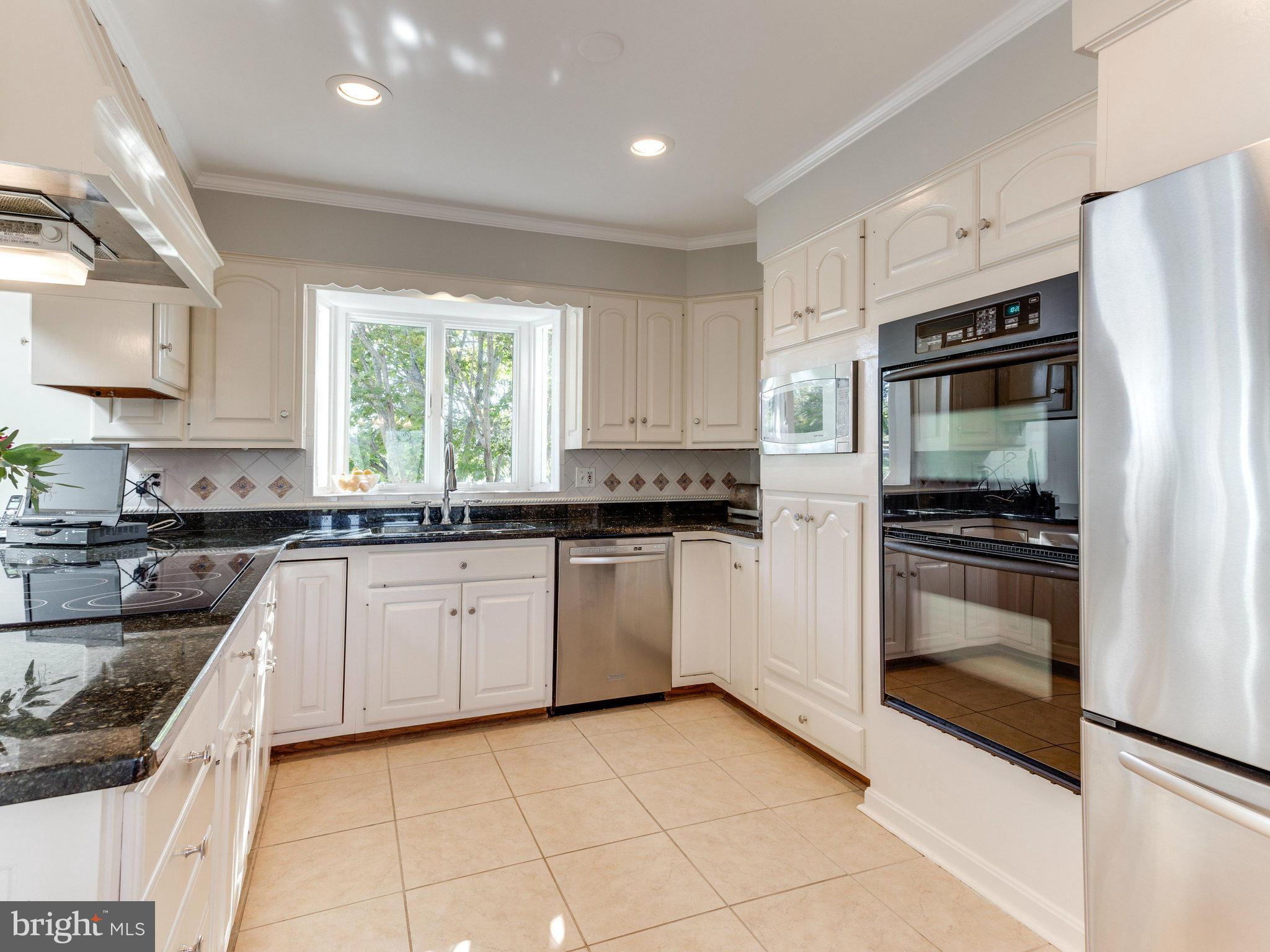 20473 Gleedsville Road Leesburg, VA 20175 - Photo 10 of 30 a kitchen with granite countertop a refrigerator and a stove top oven