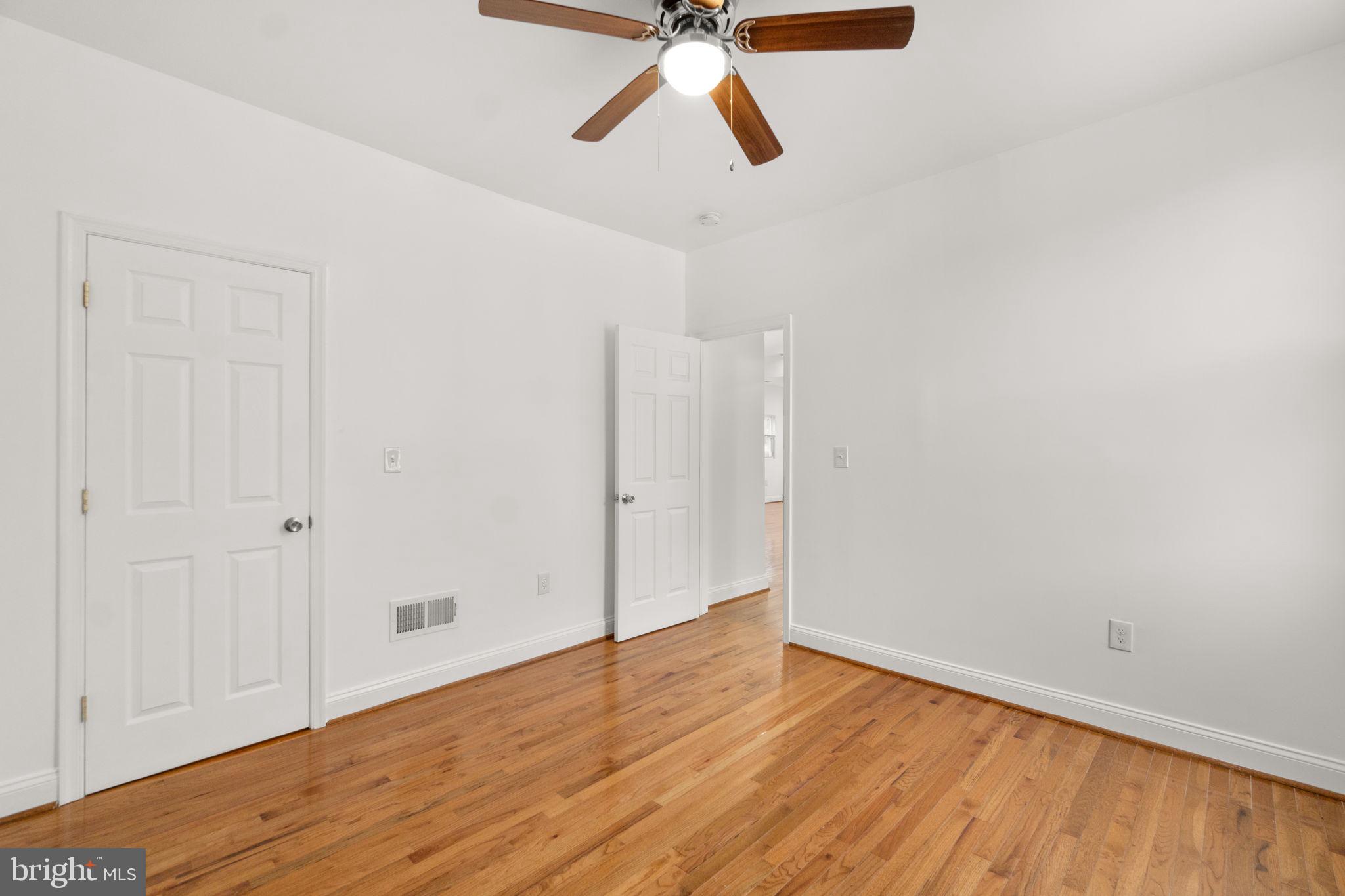 4525 Mainfield Avenue Baltimore, MD 21214 - Photo 14 of 33 a view of empty room with wooden floor
