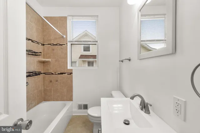 a bathroom with a sink a toilet and a bathtub