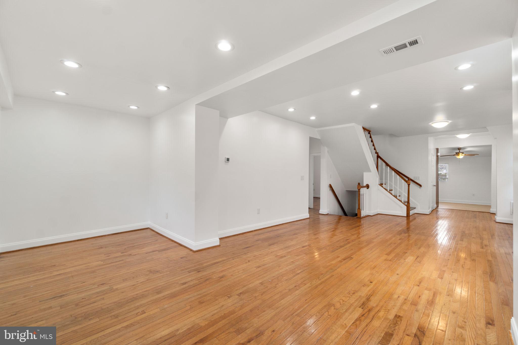 4525 Mainfield Avenue Baltimore, MD 21214 - Photo 7 of 33 a view of an empty room with wooden floor