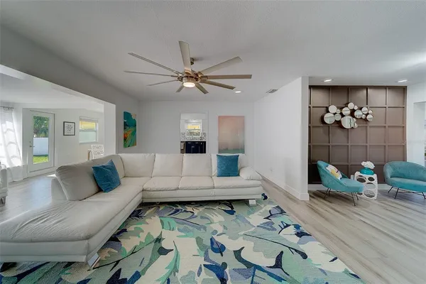 a living room with furniture and wooden floor