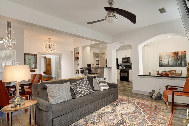 a living room with furniture and view of kitchen