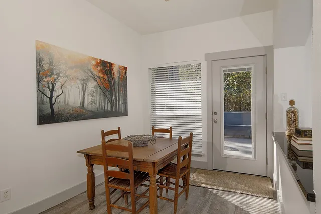 a view of a dining room with furniture and window