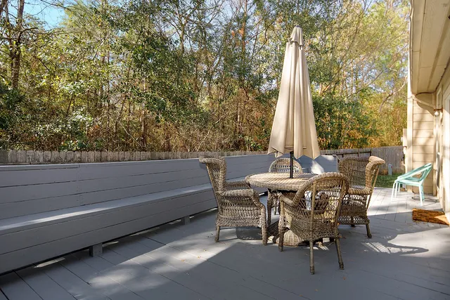 a roof deck with table and chairs