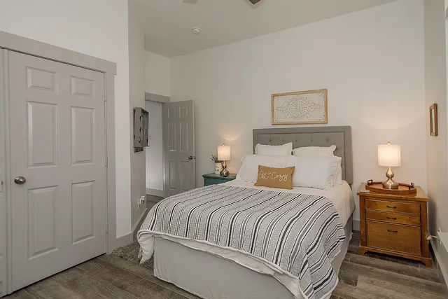 a bedroom with a bed and a lamp