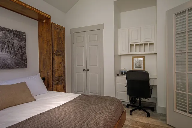 a bedroom with a bed and a chair