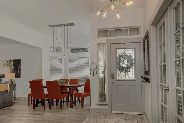 a view of a dining room with furniture and chandelier