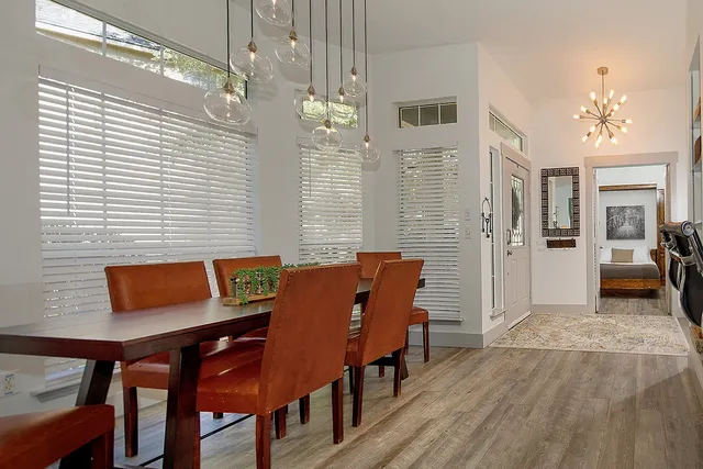 a view of a dining room with furniture and chandelier