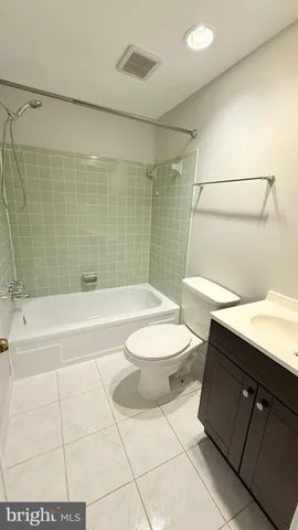 a bathroom with a toilet a sink and bathtub