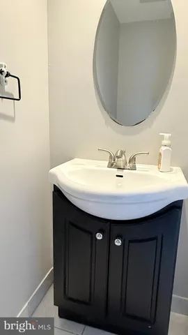 a bathroom with a sink vanity and a mirror
