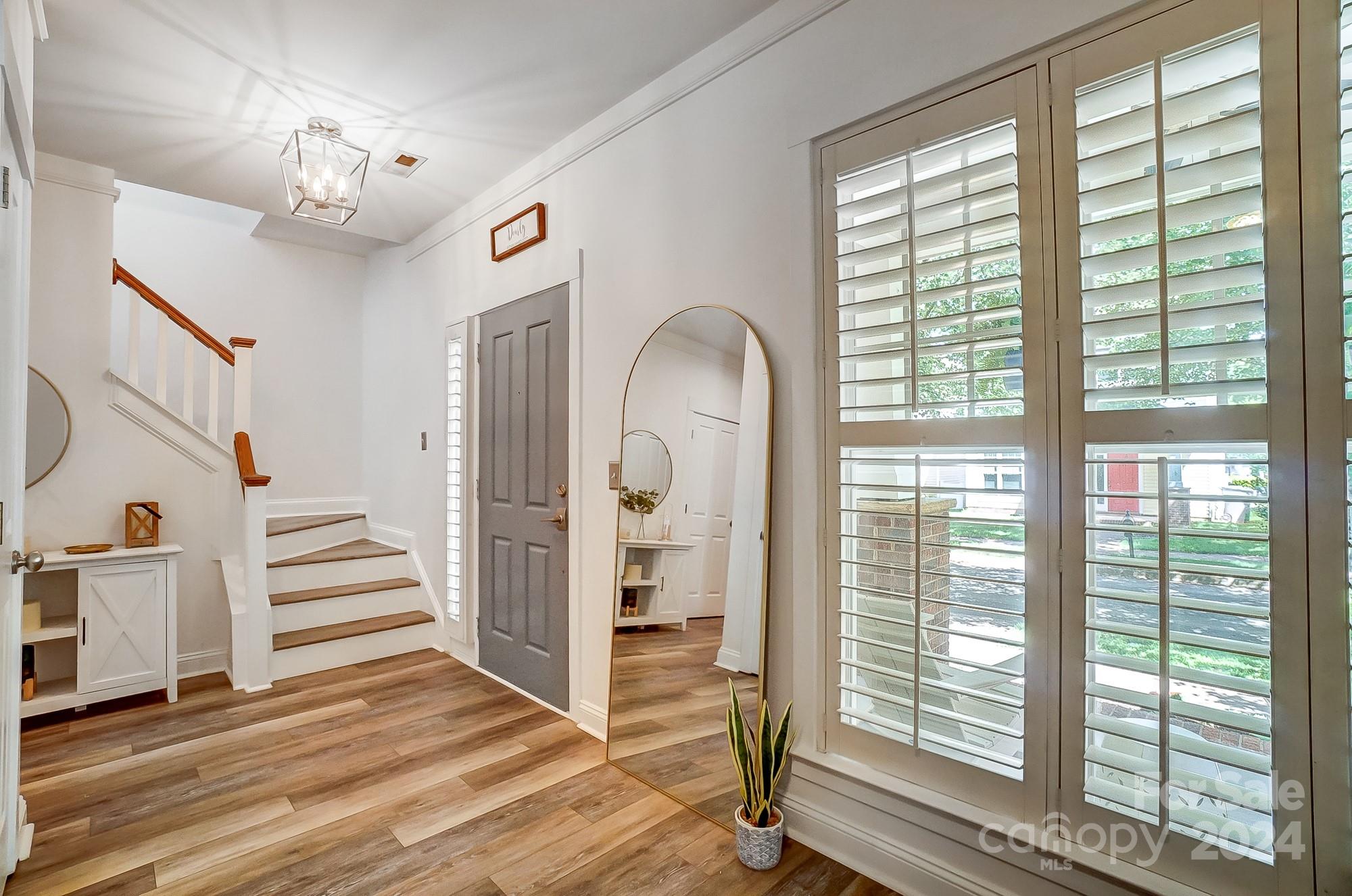 11343 Deer Ridge Lane Charlotte, NC 28277 - Photo 17 of 35 a view of a hallway with windows and stairs