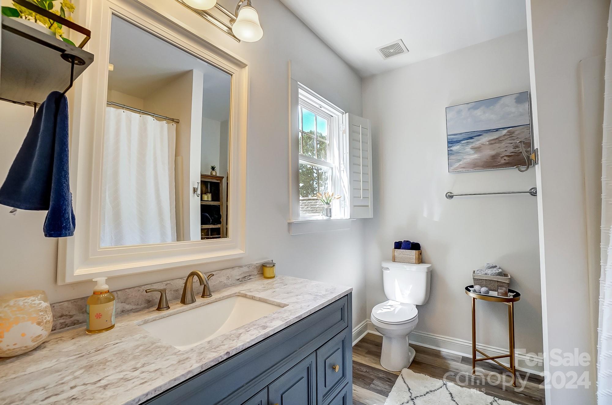 11343 Deer Ridge Lane Charlotte, NC 28277 - Photo 23 of 35 a bathroom with a granite countertop toilet sink and mirror