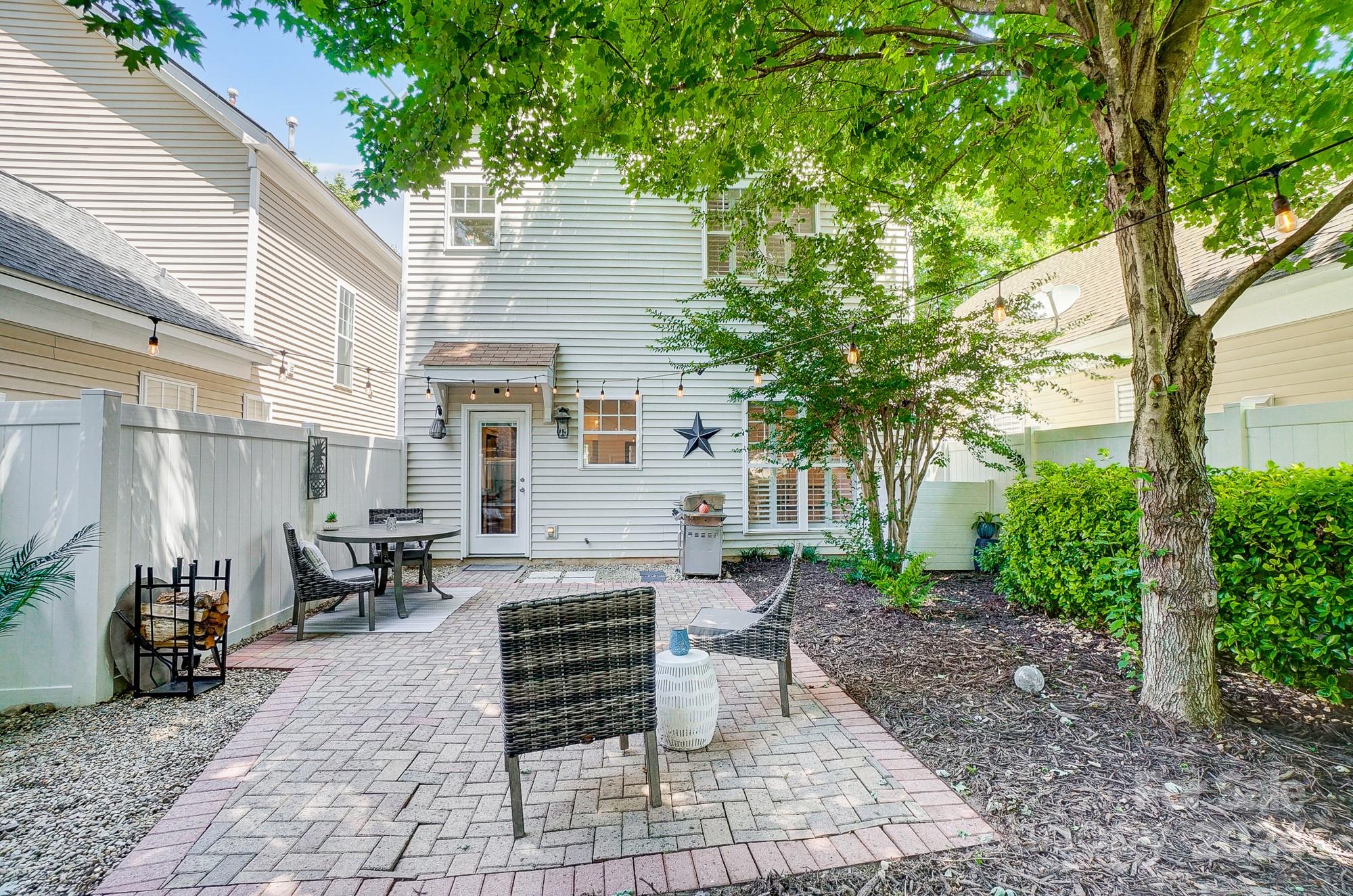 11343 Deer Ridge Lane Charlotte, NC 28277 - Photo 33 of 35 a view of a patio with table and chairs potted plants and large tree