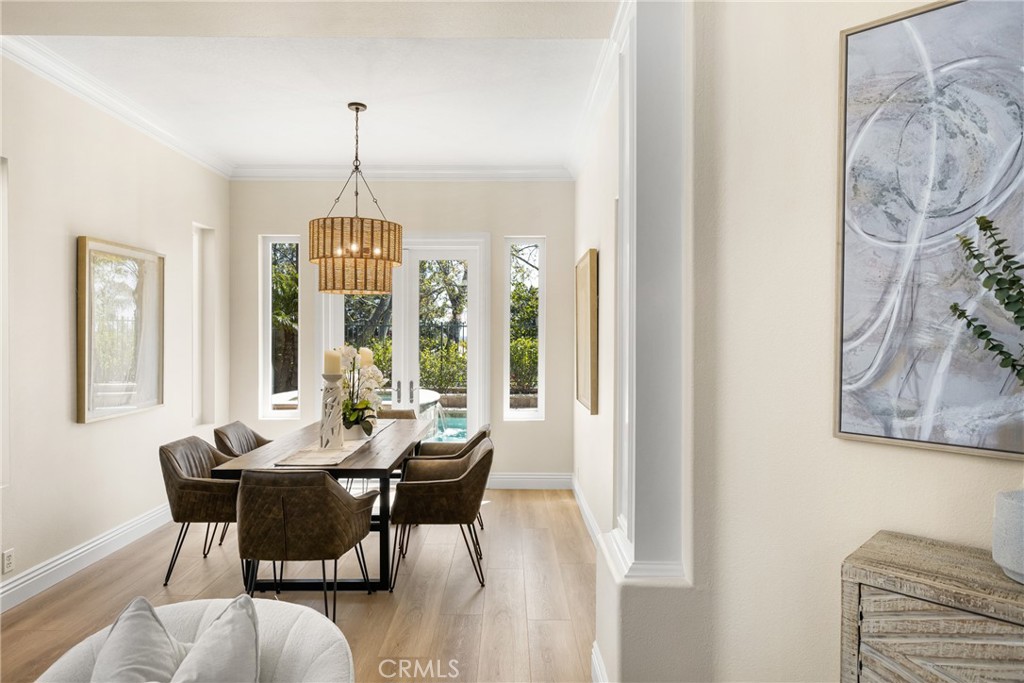 36 Mallorca Lake Forest, CA 92610 - Photo 14 of 64 a dining room with furniture a chandelier and wooden floor