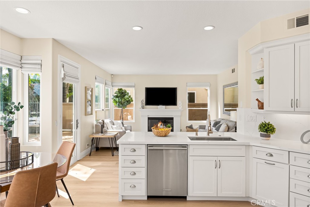 36 Mallorca Lake Forest, CA 92610 - Photo 18 of 64 a living room with stainless steel appliances furniture a fireplace and a flat screen tv