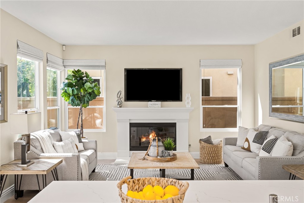 36 Mallorca Lake Forest, CA 92610 - Photo 19 of 64 a living room with furniture a fireplace and a flat screen tv