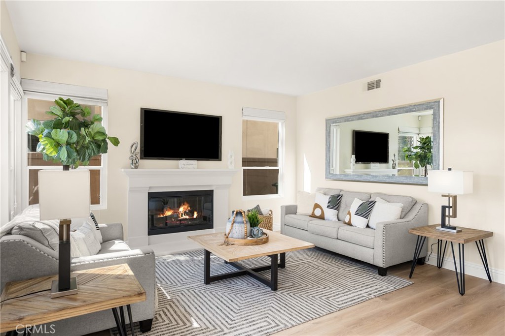 36 Mallorca Lake Forest, CA 92610 - Photo 21 of 64 a living room with furniture a fireplace and a flat screen tv