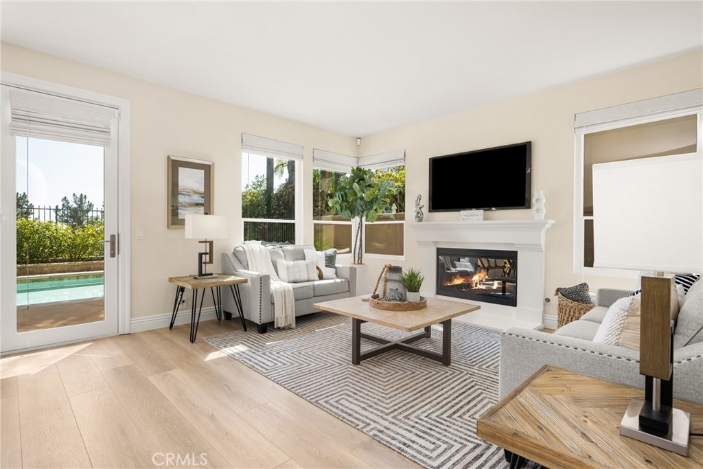36 Mallorca Lake Forest, CA 92610 - Photo 22 of 64 a living room with furniture a fireplace and a flat screen tv