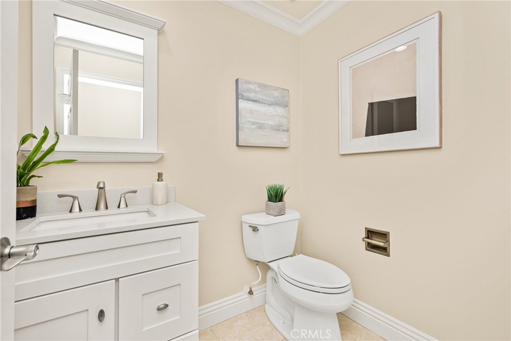 36 Mallorca Lake Forest, CA 92610 - Photo 32 of 64 a bathroom with a toilet sink vanity and mirror