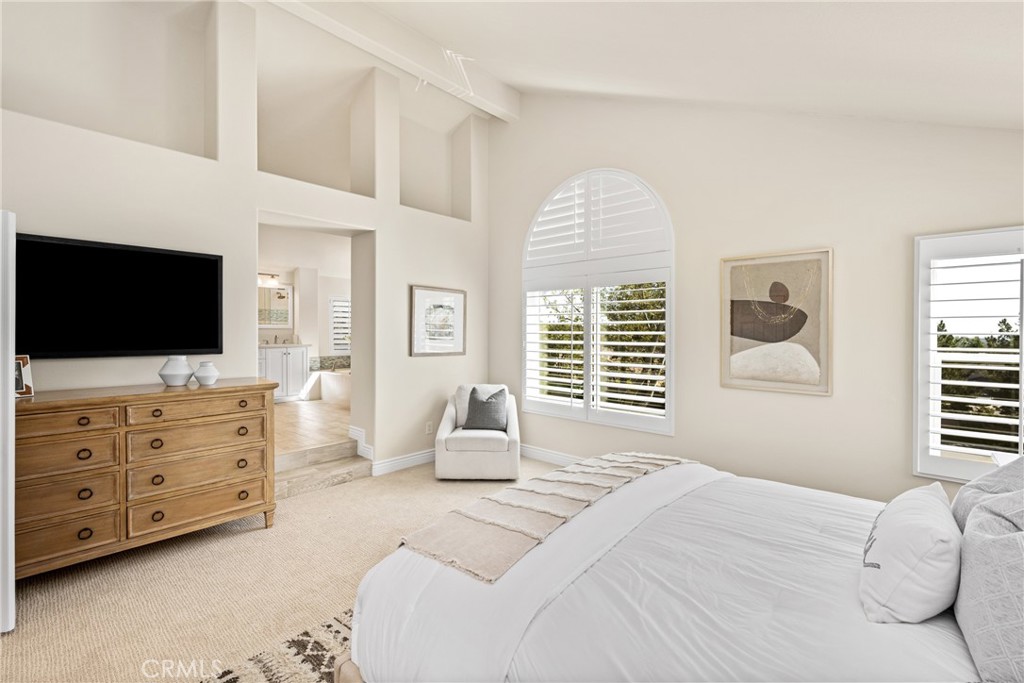 36 Mallorca Lake Forest, CA 92610 - Photo 39 of 64 a bedroom with a large bed and flat tv screen on dresser