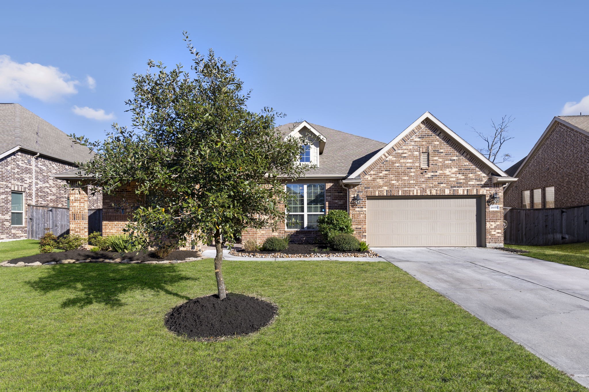 a front view of a house with a yard and garage