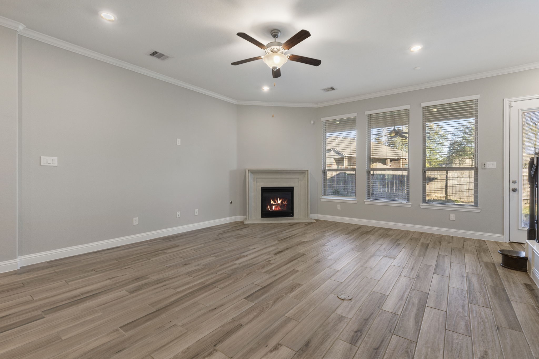 18855 Collins View Drive New Caney, TX 77357 - Photo 14 of 50 a view of an empty room with a window and wooden floor