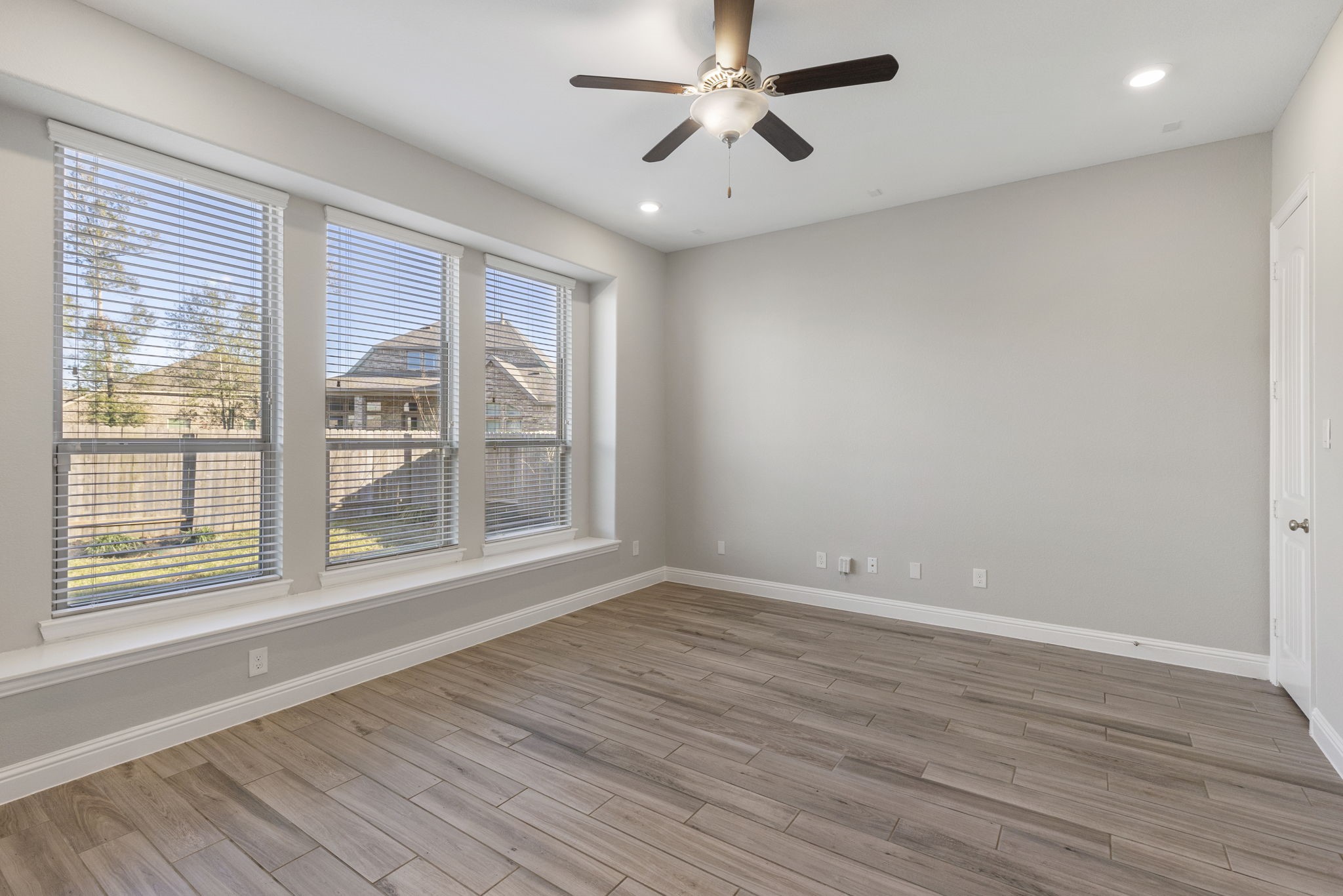 18855 Collins View Drive New Caney, TX 77357 - Photo 16 of 50 a view of an empty room with a window and wooden floor