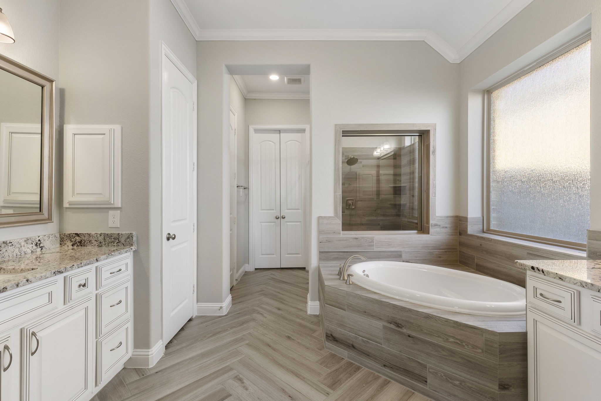 18855 Collins View Drive New Caney, TX 77357 - Photo 17 of 50 a bathroom with a granite countertop sink and mirror with bathtub