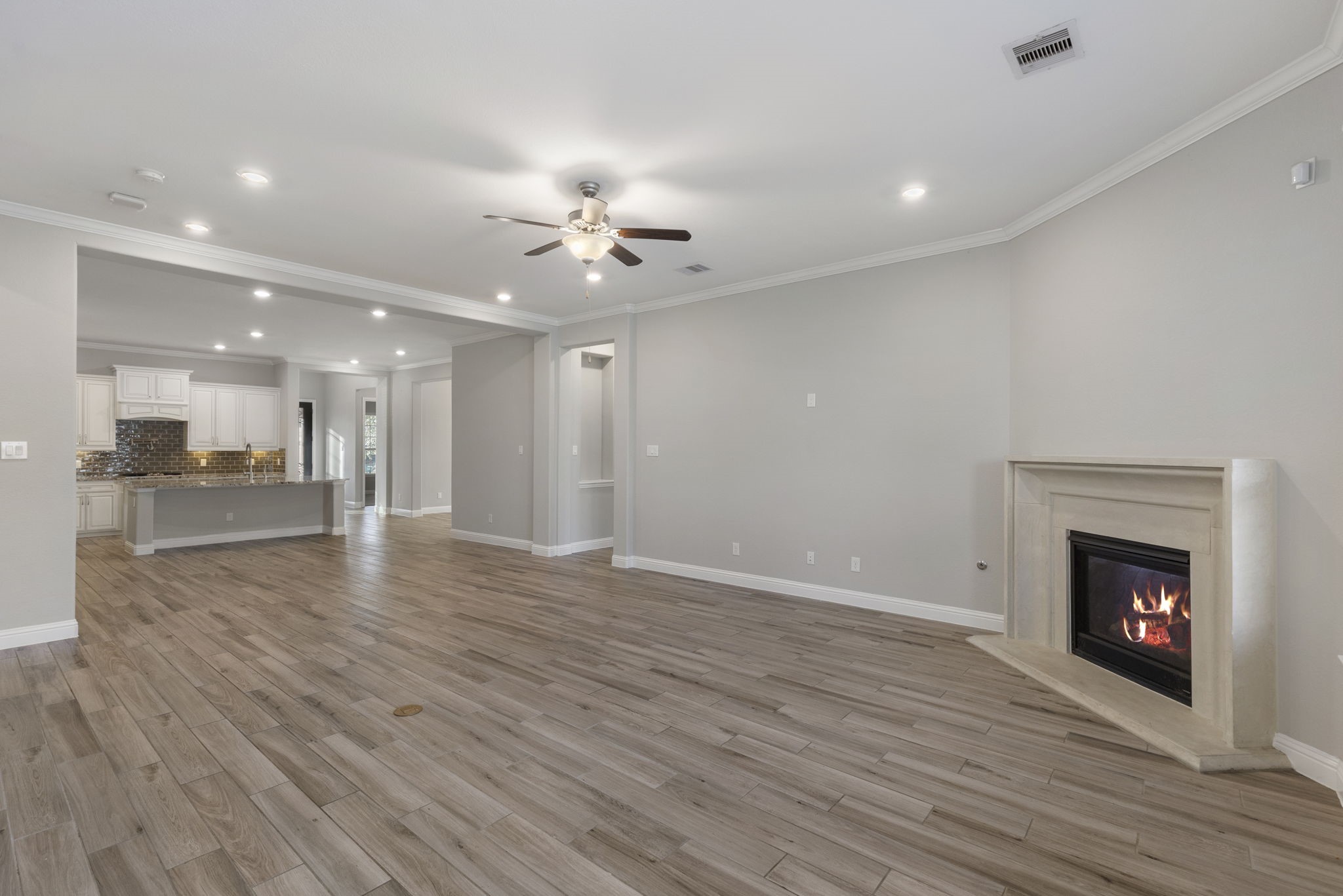 18855 Collins View Drive New Caney, TX 77357 - Photo 22 of 50 a view of an empty room with wooden floor and a fireplace