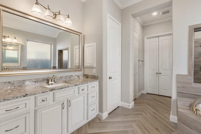 a bathroom with a granite countertop sink and a mirror