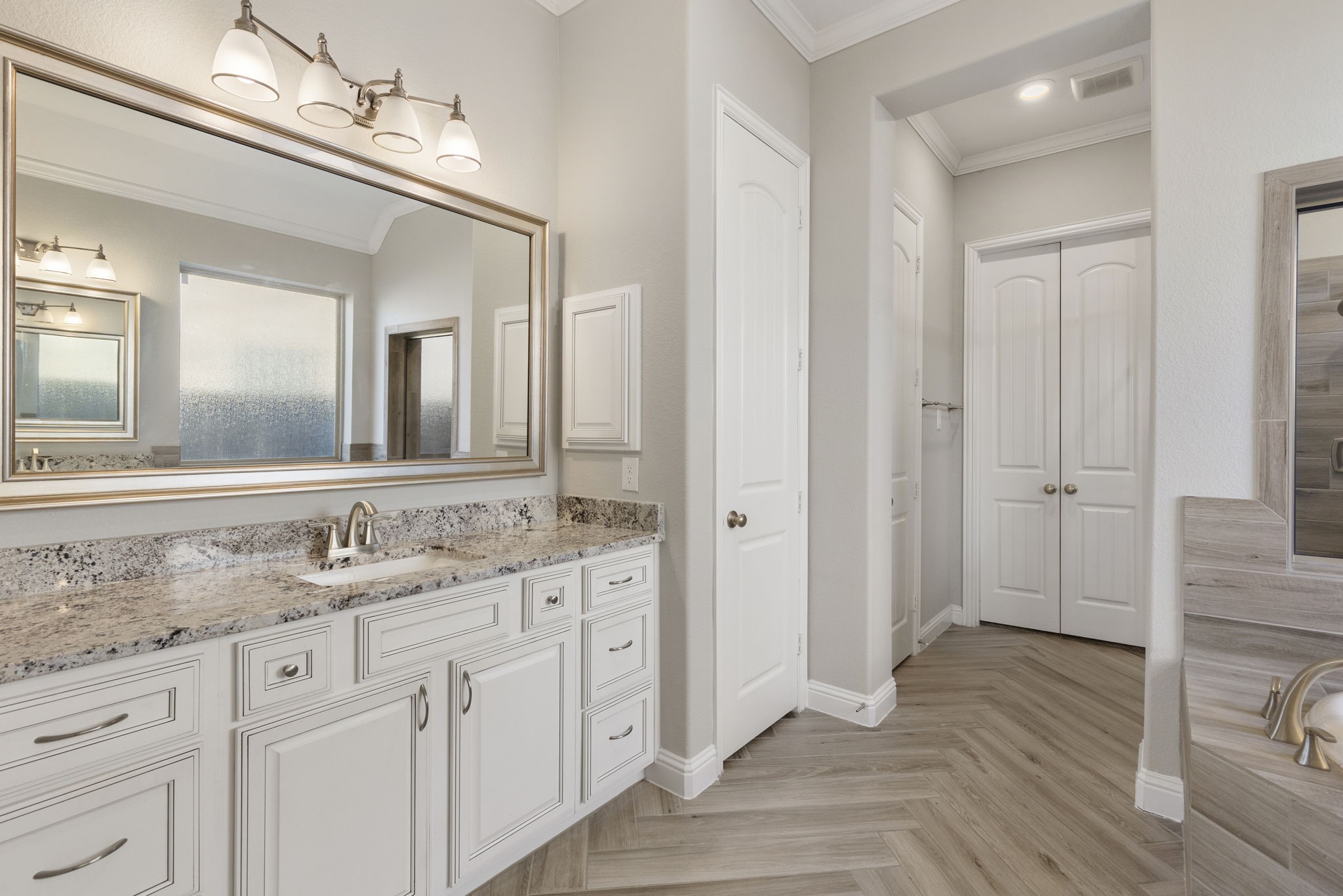 18855 Collins View Drive New Caney, TX 77357 - Photo 24 of 50 a bathroom with a granite countertop sink and a mirror