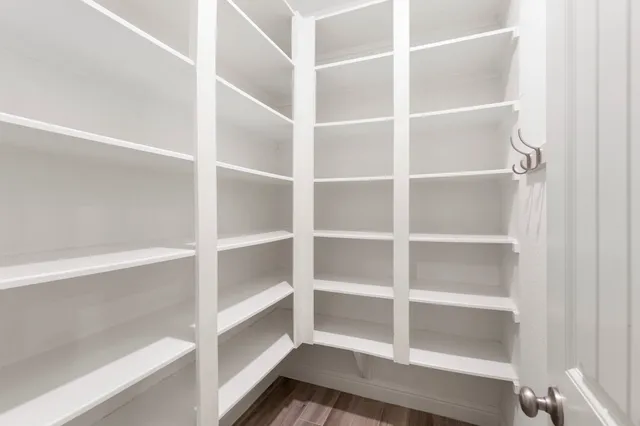 a view of walk in closet with empty racks