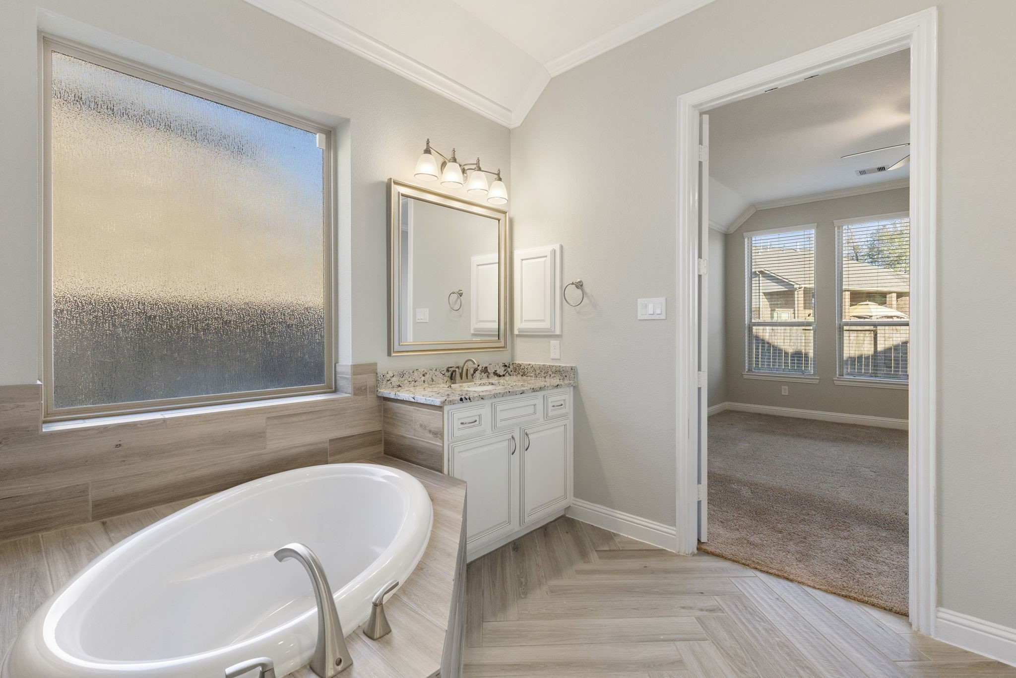 18855 Collins View Drive New Caney, TX 77357 - Photo 40 of 50 a bathroom with a granite countertop tub sink and mirror