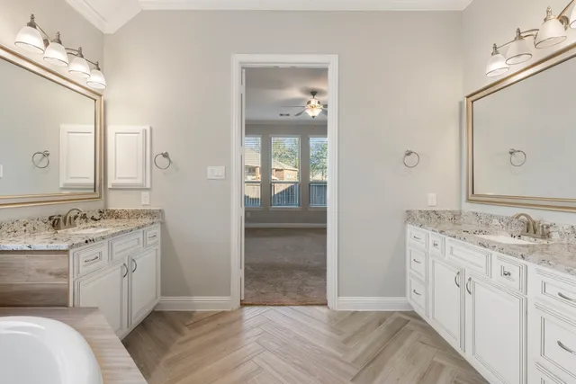 a spacious bathroom with a granite countertop sink and a mirror