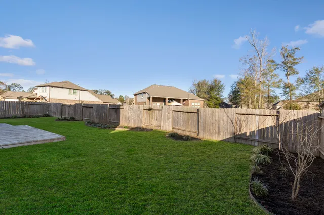 a view of a garden with a house in the background
