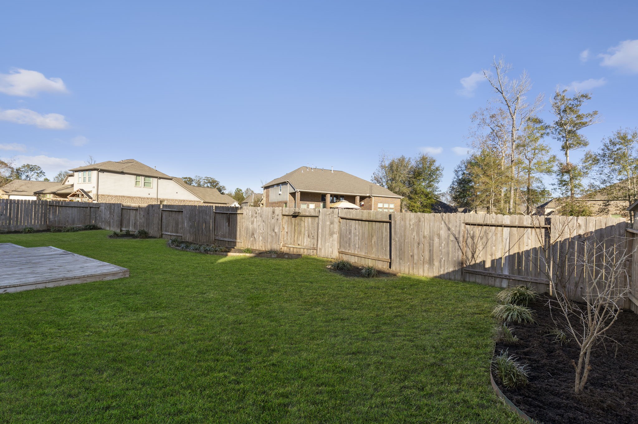 18855 Collins View Drive New Caney, TX 77357 - Photo 47 of 50 a view of a garden with a house in the background